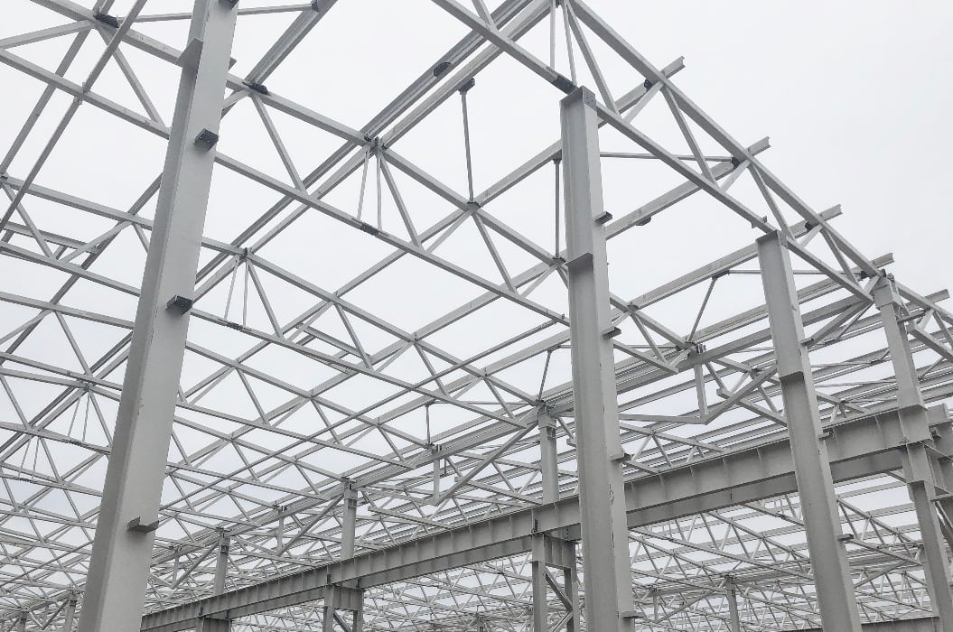 Truss ceiling and metal pillars and girders. Support constructions.